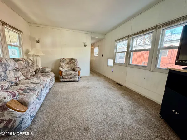 a spacious bedroom with a bed and large windows