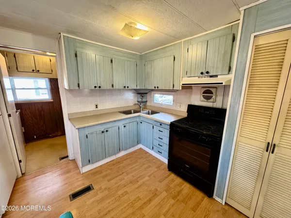 a kitchen with a sink stove and cabinets