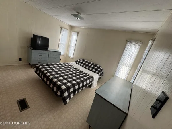 a bedroom with bed and window