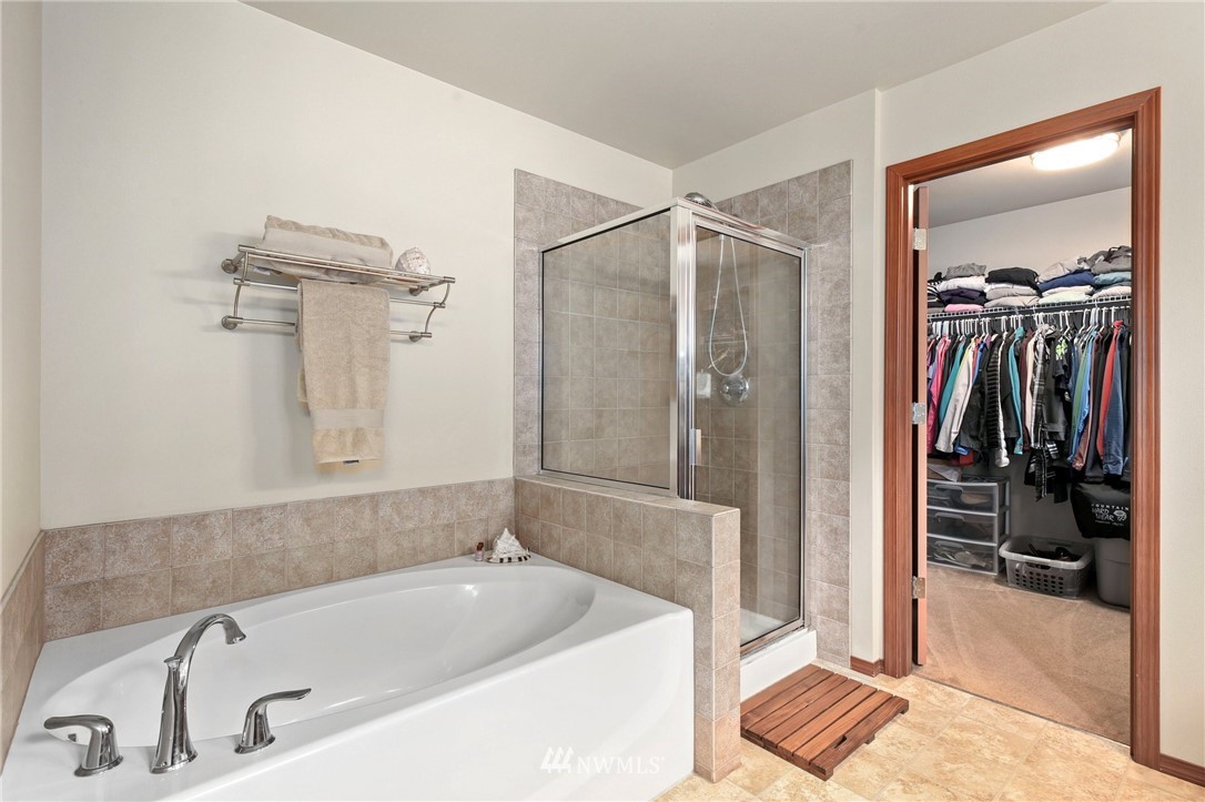 1374 Foreman Road DuPont, WA 98327 - Photo 22 of 36 a bathroom with a tub a sink and a shower