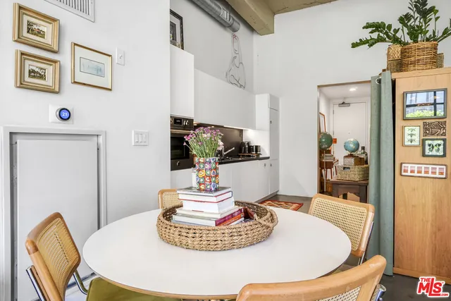 a dining room with furniture and wooden floor