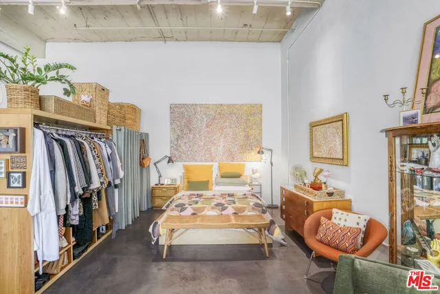 a bedroom with furniture and a rug