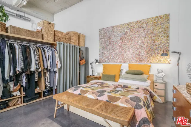 a bed sitting in a bedroom next to a window