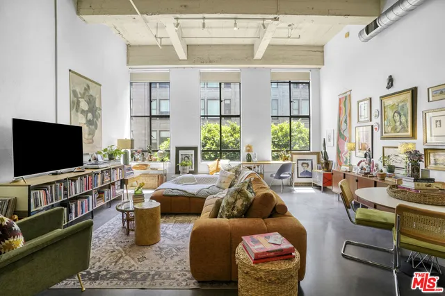 a living room with furniture large window and flat screen tv
