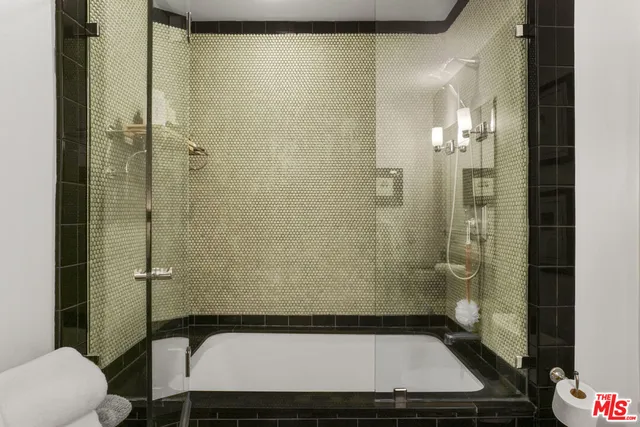 a bathroom with a granite countertop sink a toilet and shower