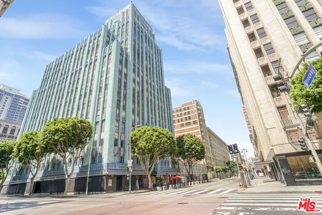 a view of a tall building next to a road