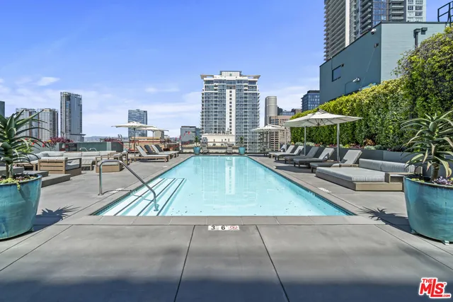 a view of swimming pool with outdoor seating and plants