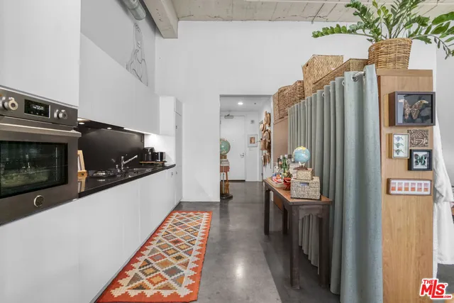 a kitchen with stainless steel appliances kitchen island granite countertop a refrigerator and a stove