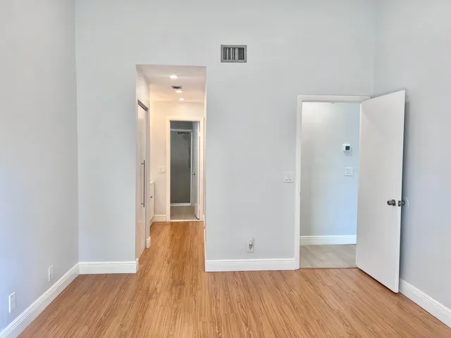 a view of hallway with wooden floor