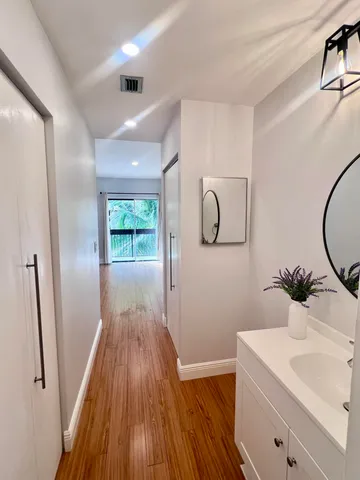 a view of a hallway to a livingroom and wooden floor