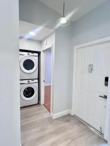 wooden floor in a kitchen and a sink a washer dryer