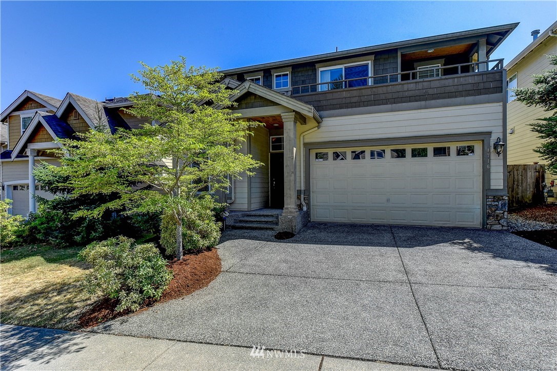 1716 235th Place Southwest Bothell, WA 98021 - Photo 1 of 25 a front view of a house with a yard and garage