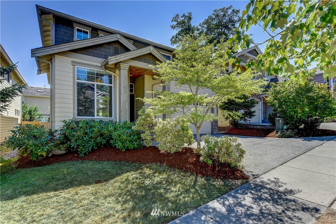 1716 235th Place Southwest Bothell, WA 98021 - Photo 2 of 25 a front view of a house with a yard
