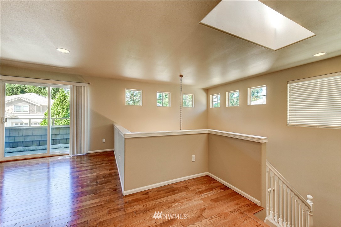 1716 235th Place Southwest Bothell, WA 98021 - Photo 12 of 25 a view of an empty room with wooden floor and a window