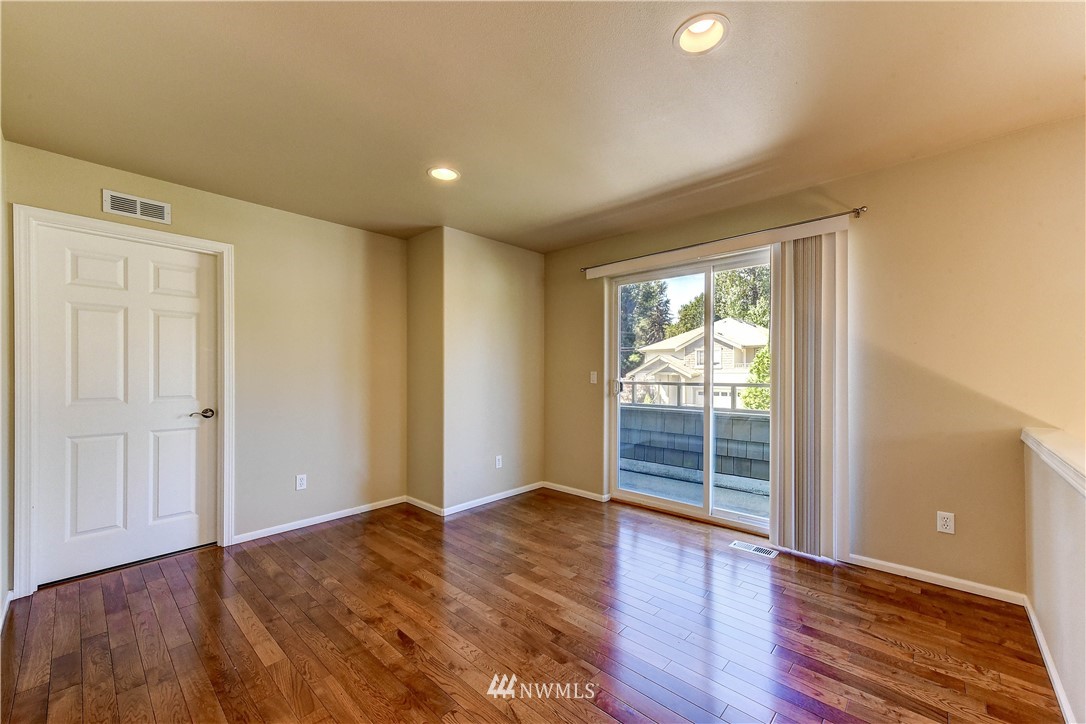 1716 235th Place Southwest Bothell, WA 98021 - Photo 13 of 25 wooden floor in an empty room with a window