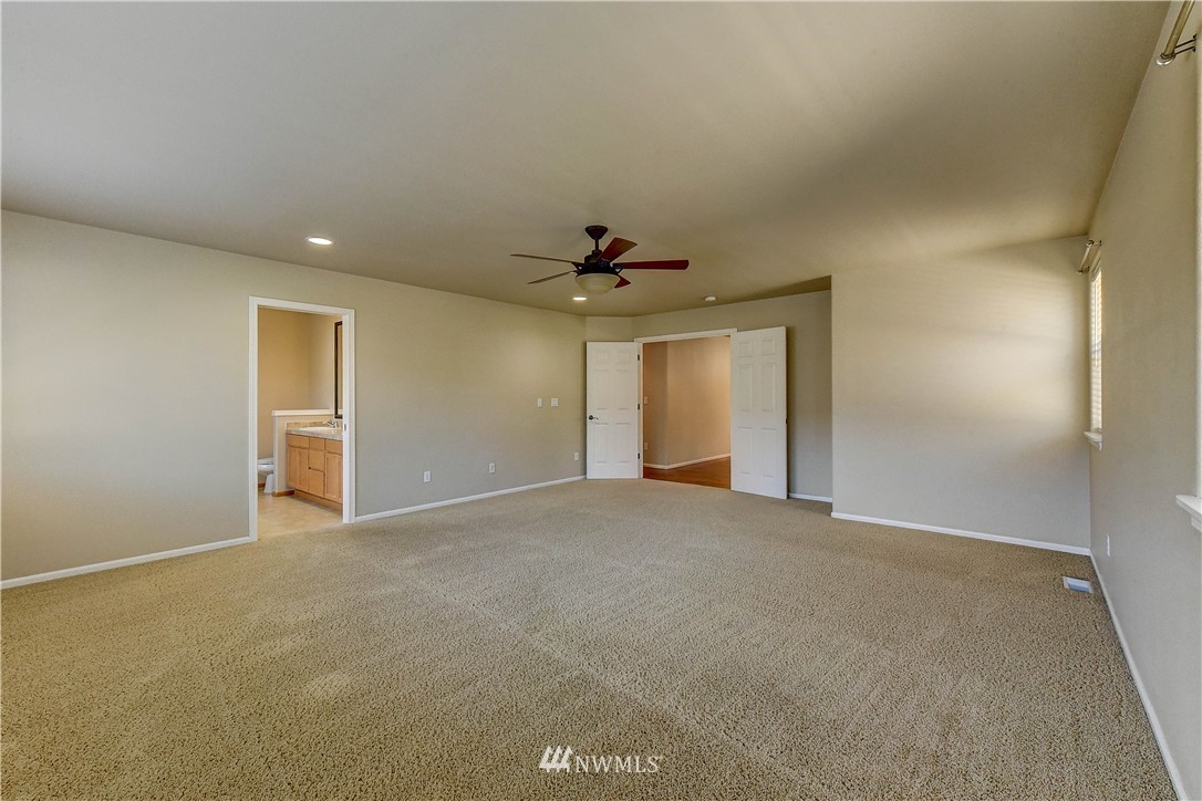 1716 235th Place Southwest Bothell, WA 98021 - Photo 15 of 25 a view of an empty room with a ceiling fan