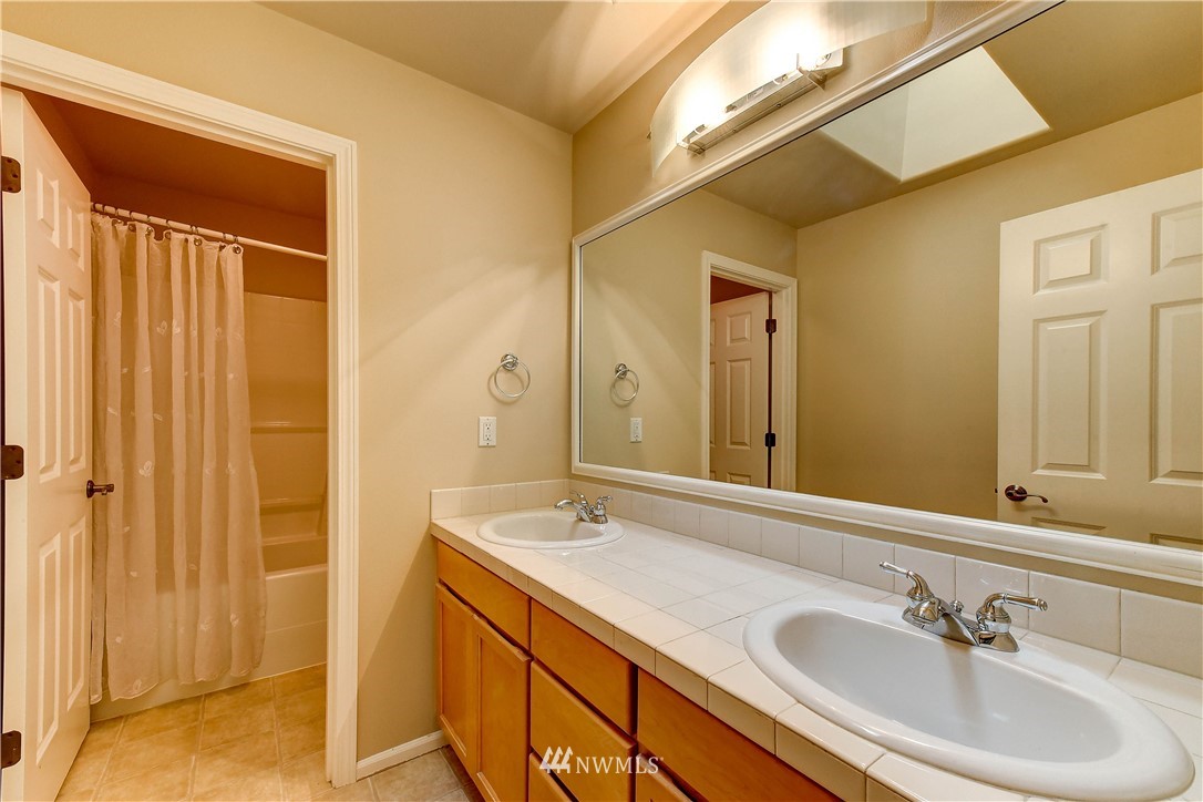 1716 235th Place Southwest Bothell, WA 98021 - Photo 19 of 25 a bathroom with a sink and a mirror