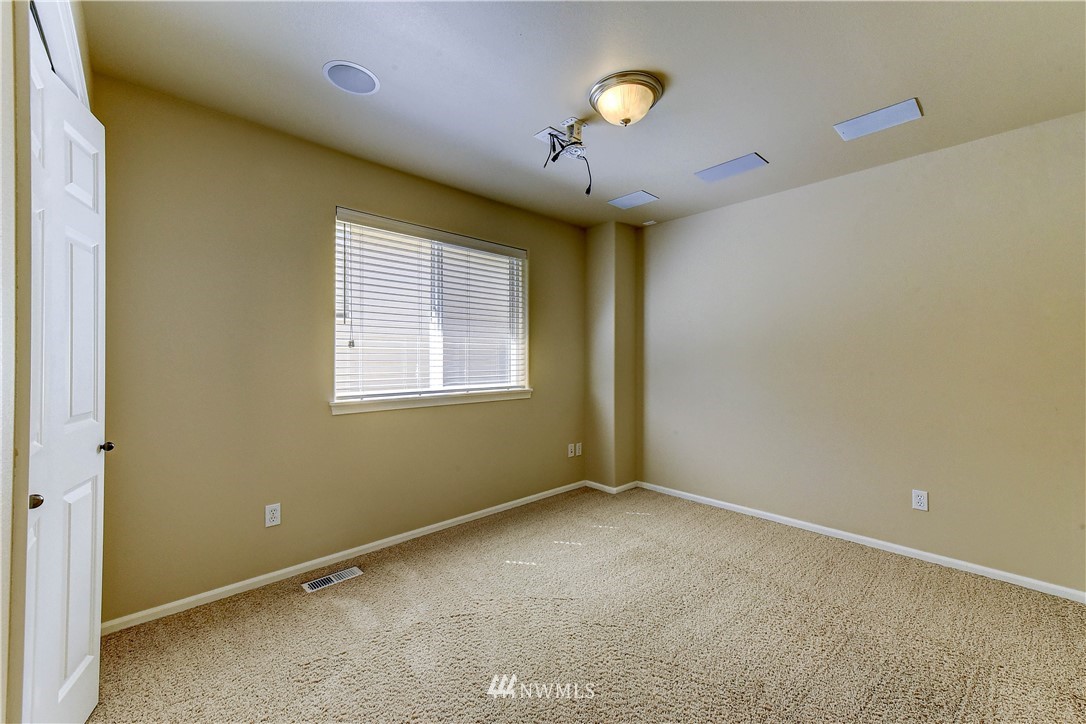 1716 235th Place Southwest Bothell, WA 98021 - Photo 20 of 25 an empty room with a window