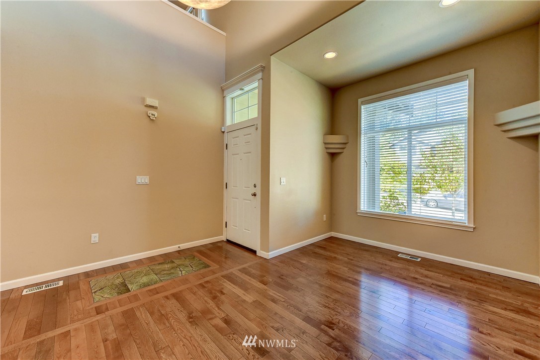 1716 235th Place Southwest Bothell, WA 98021 - Photo 4 of 25 a view of an empty room with wooden floor and a window