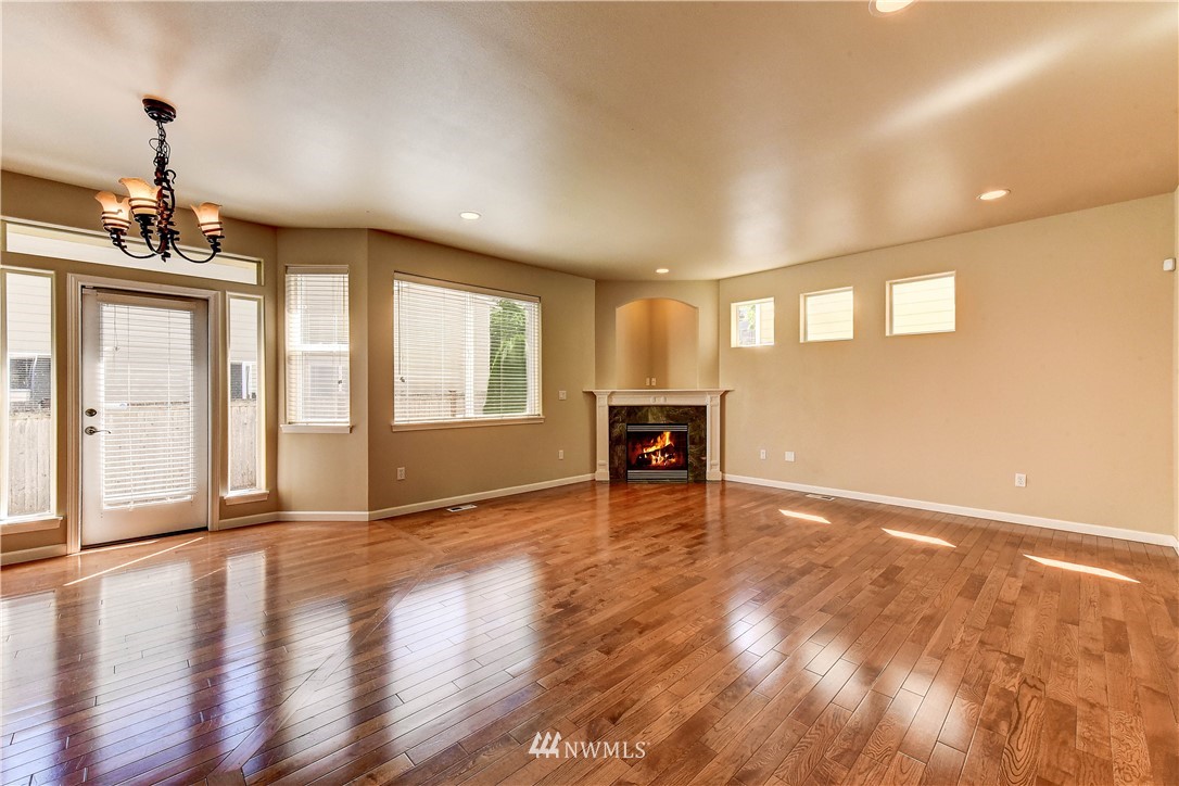 1716 235th Place Southwest Bothell, WA 98021 - Photo 10 of 25 a view of an empty room with a window and wooden floor