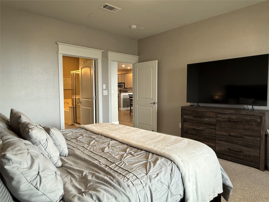 17808 Maritime Point, Unit 301 Jonestown, TX 78645 - Photo 15 of 40 Bedroom featuring carpet flooring and connected bathroom