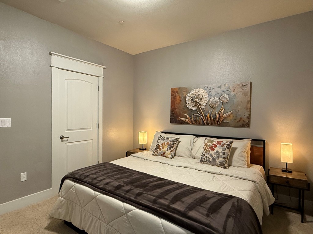 17808 Maritime Point, Unit 301 Jonestown, TX 78645 - Photo 18 of 40 a bedroom with a bed and painting on the wall