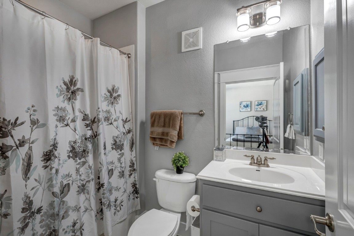 17808 Maritime Point, Unit 301 Jonestown, TX 78645 - Photo 19 of 40 a bathroom with a sink a toilet and shower