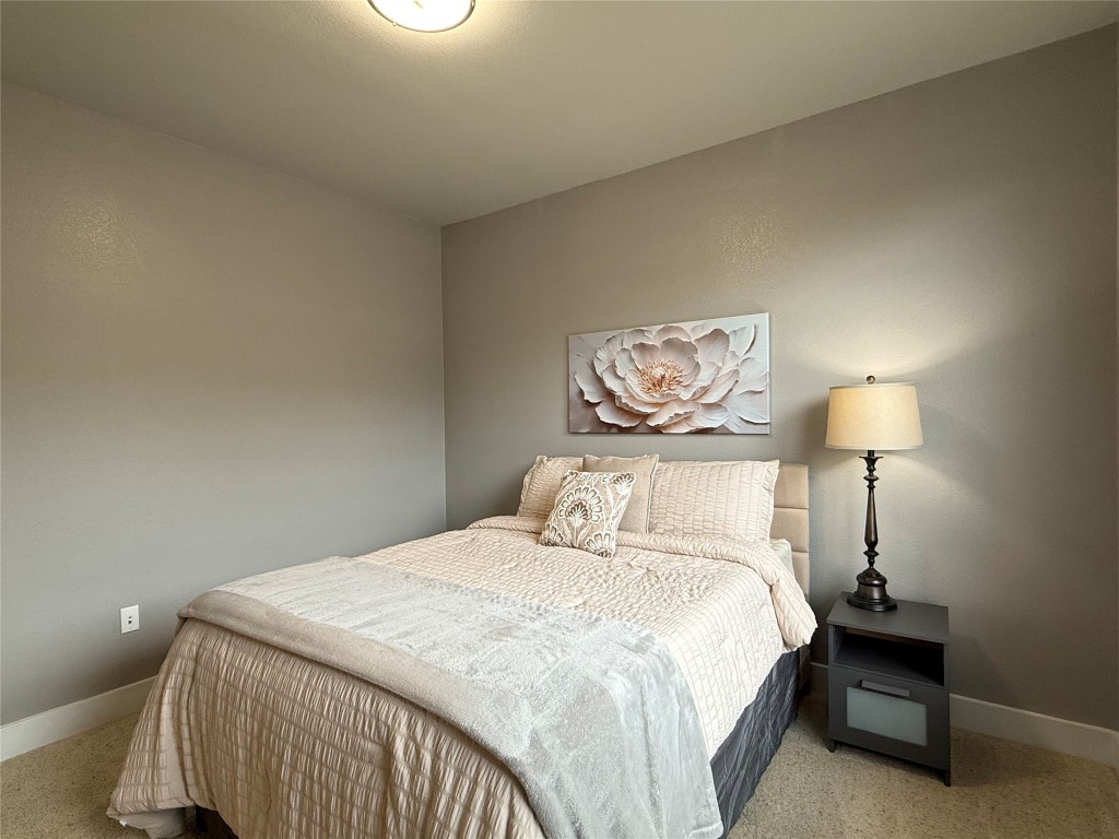 17808 Maritime Point, Unit 301 Jonestown, TX 78645 - Photo 21 of 40 a bedroom with a bed and a lamp