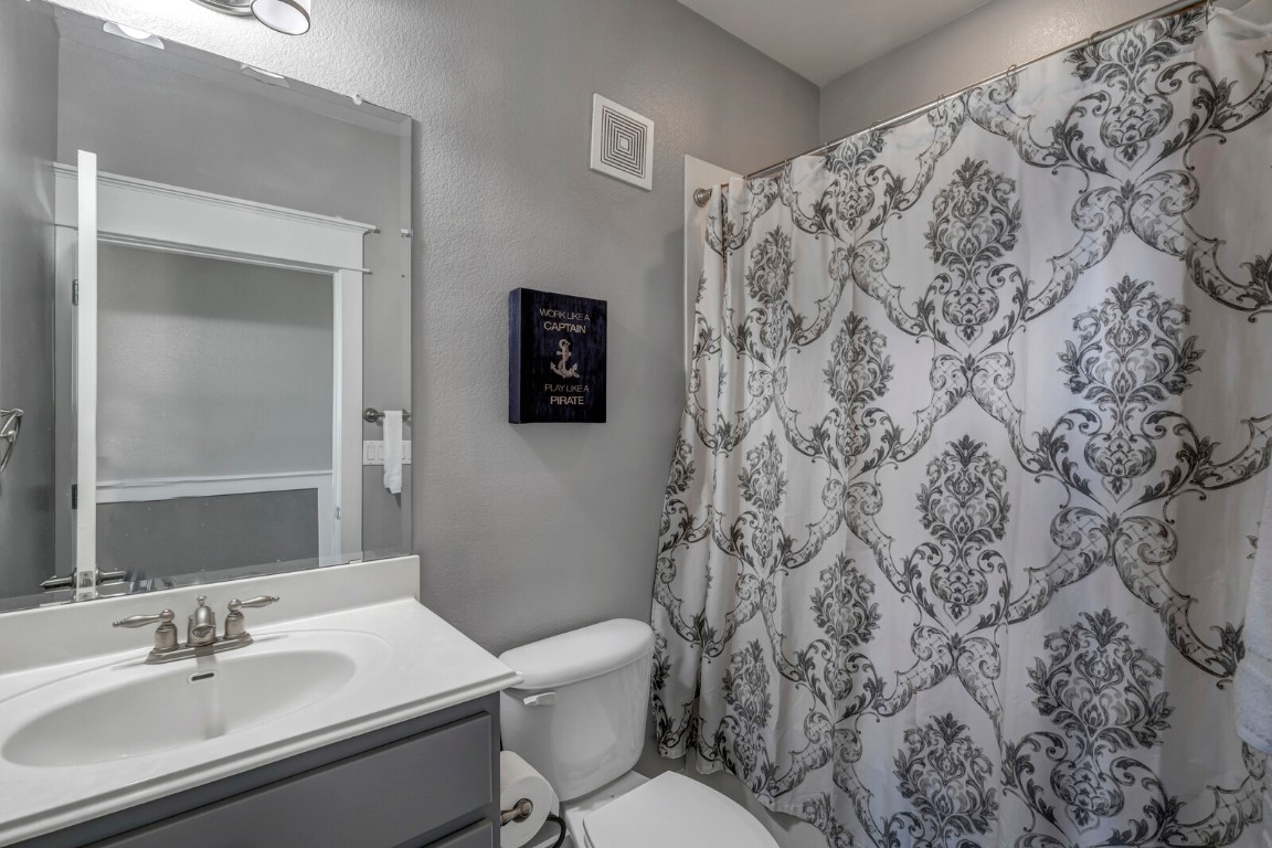17808 Maritime Point, Unit 301 Jonestown, TX 78645 - Photo 22 of 40 a white toilet sitting next to a bathroom sink