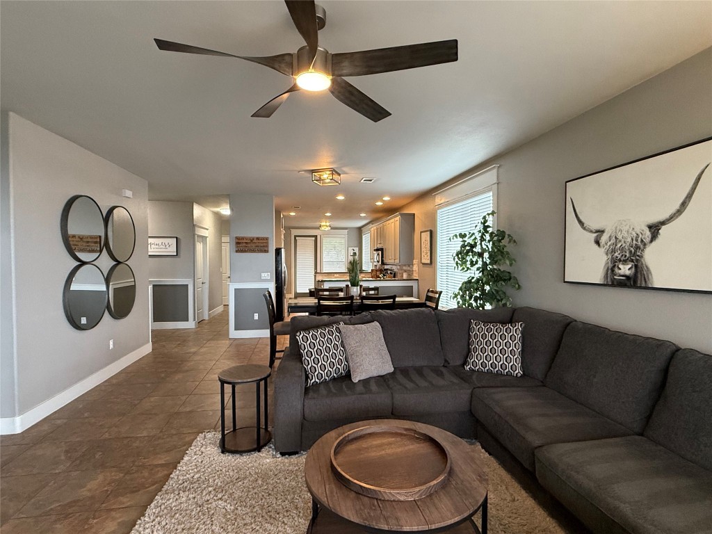 17808 Maritime Point, Unit 301 Jonestown, TX 78645 - Photo 9 of 40 a living room with furniture a chandelier and a rug