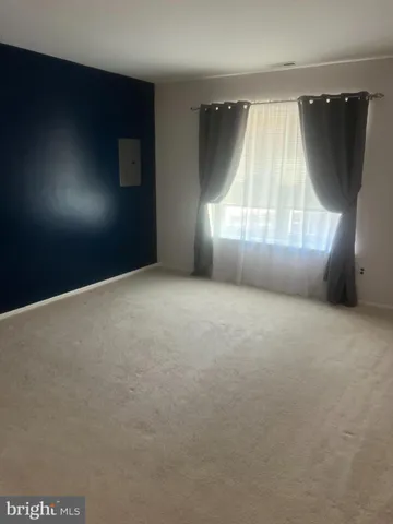 an empty room with windows and entrance