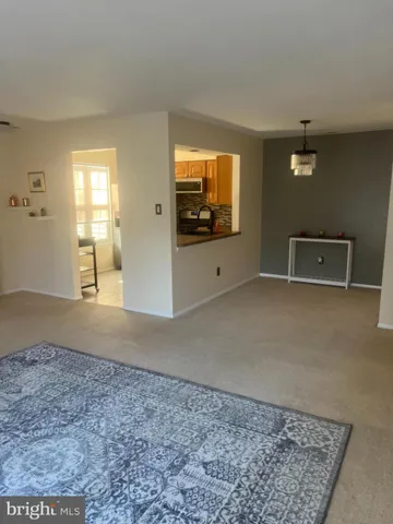 a living room with a flat screen tv and a rug