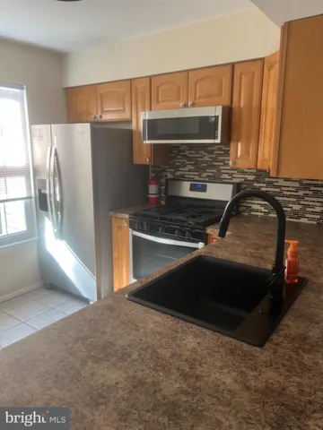 a kitchen with a sink and a refrigerator
