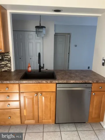 a kitchen with granite countertop a sink and cabinets