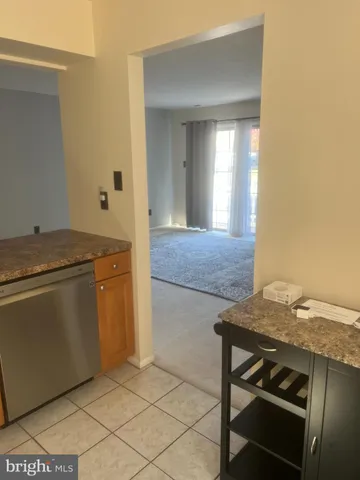 a kitchen with a sink cabinets and wooden floor