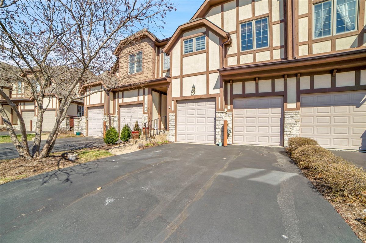 12704 Wild Rye Court Plainfield, IL 60585 - Photo 51 of 51 a front view of a house with a yard and garage