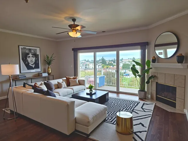 a living room with furniture a fireplace and a large window