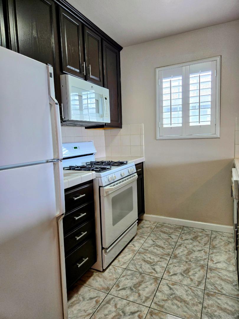 551 Merritt Avenue, Unit 1 Oakland, CA 94610 - Photo 7 of 20 a kitchen with stainless steel appliances a stove and a refrigerator