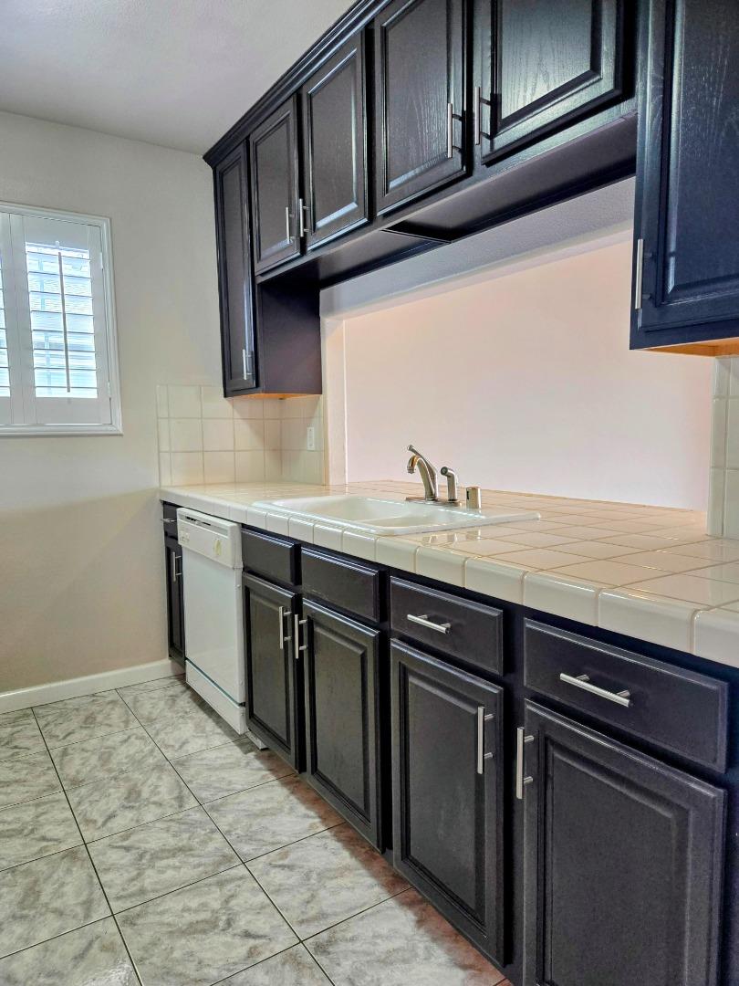551 Merritt Avenue, Unit 1 Oakland, CA 94610 - Photo 8 of 20 a kitchen with stainless steel appliances granite countertop a sink stove and cabinets
