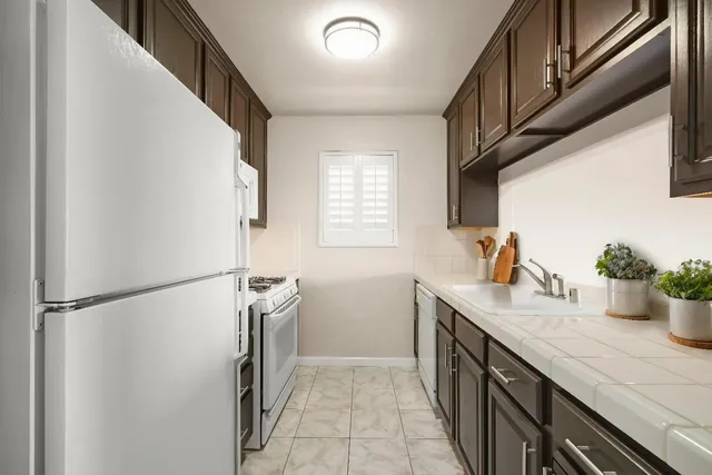 a kitchen with a sink and refrigerator