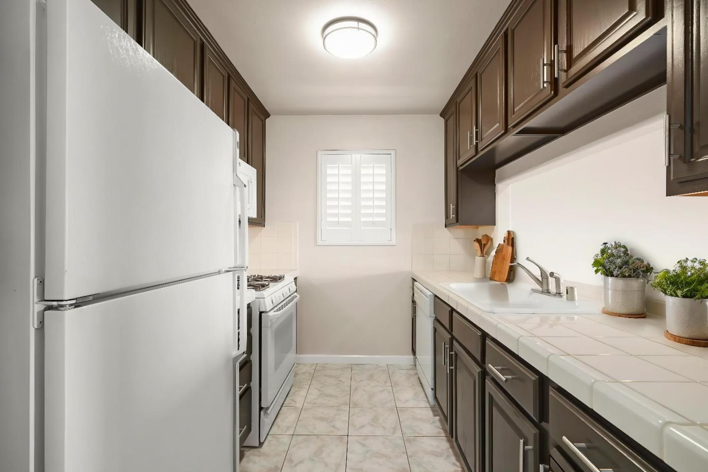 551 Merritt Avenue, Unit 1 Oakland, CA 94610 - Photo 9 of 20 a kitchen with a sink and refrigerator