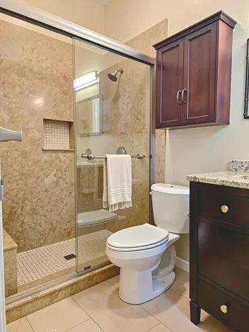 a bathroom with a toilet a sink and shower