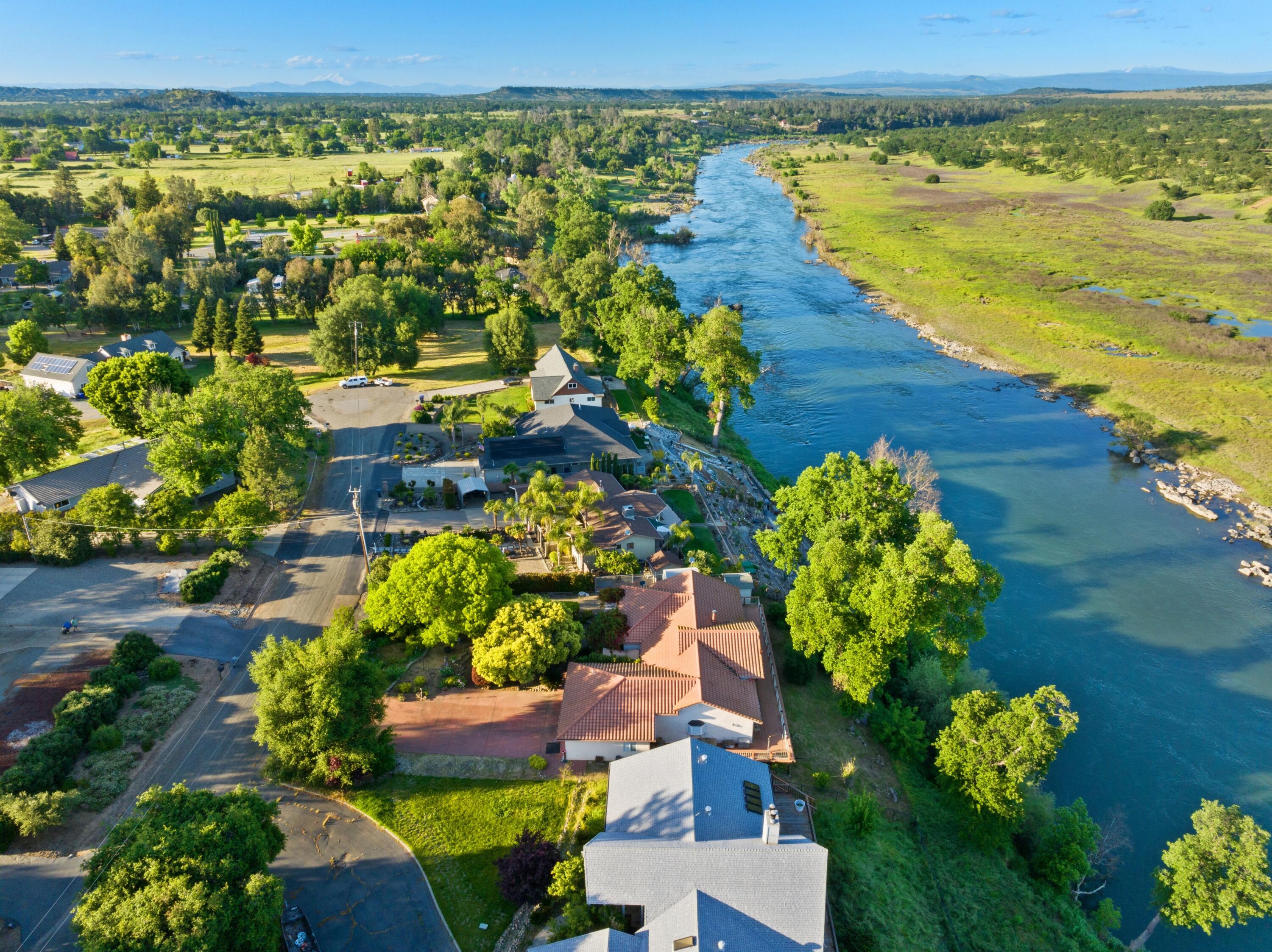 15560 China Rapids Drive Red Bluff, CA 96080 - Photo 11 of 43 a view of a lake with a building in the background