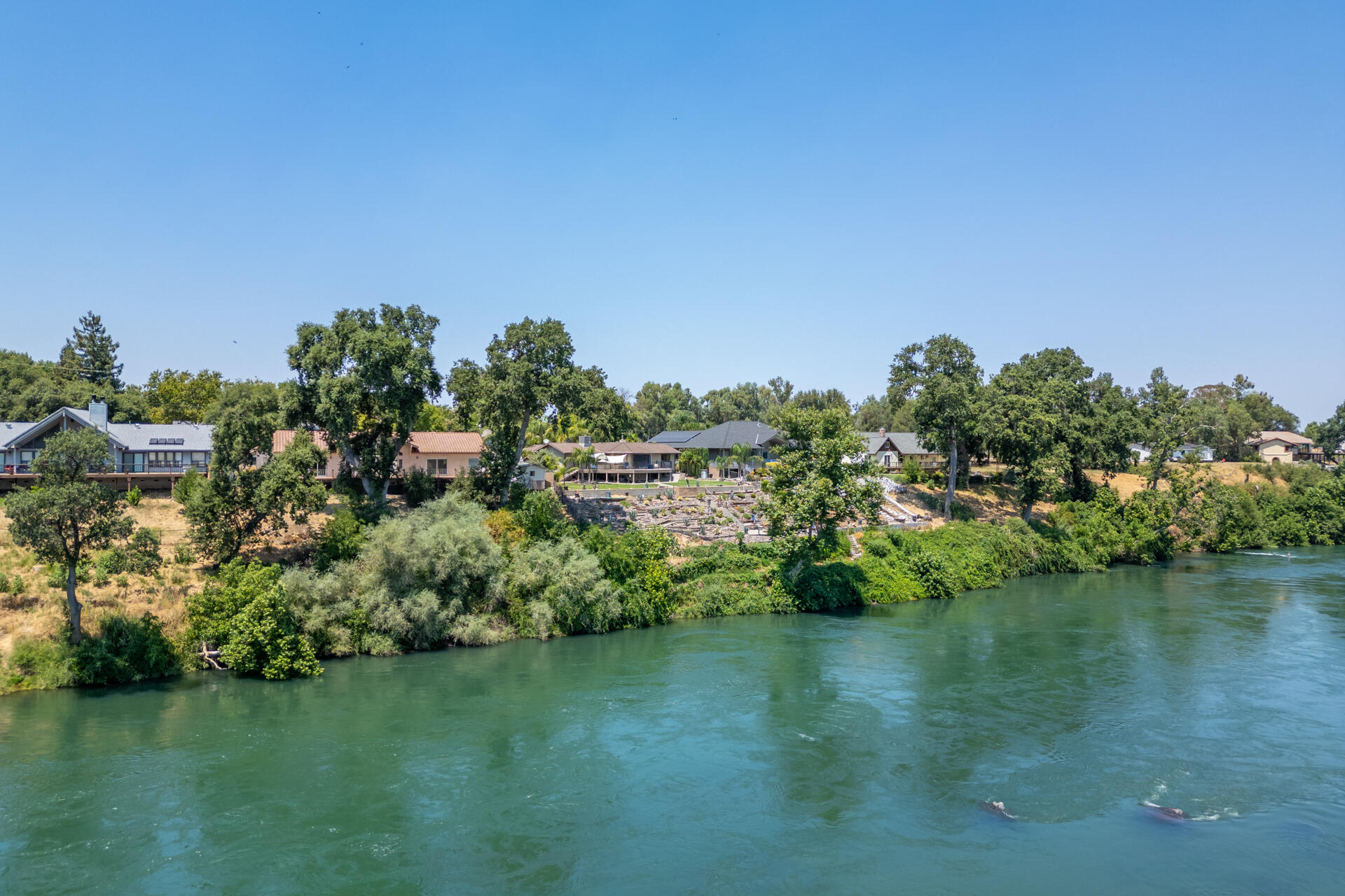 15560 China Rapids Drive Red Bluff, CA 96080 - Photo 2 of 43 a view of a lake with houses