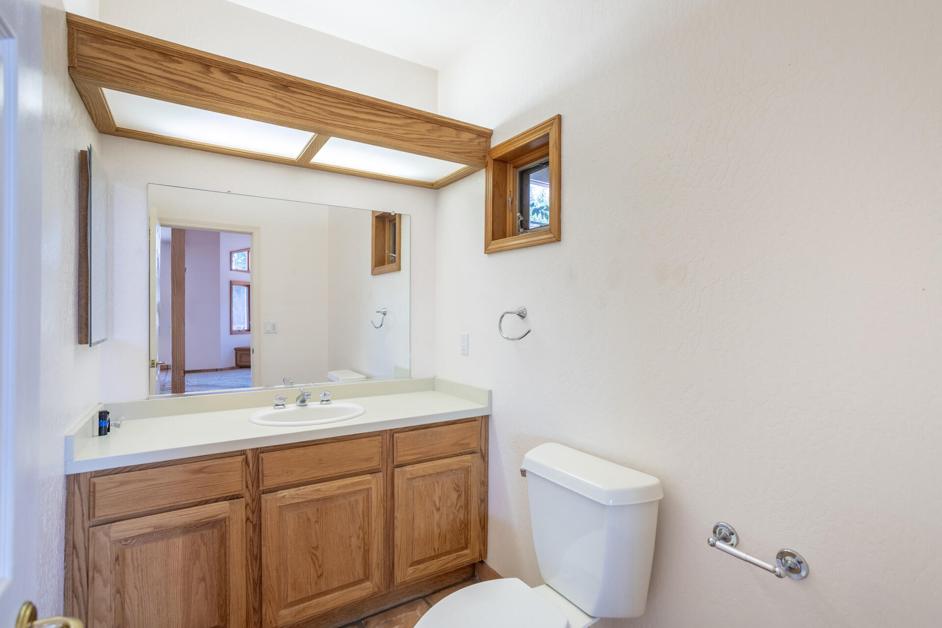 15560 China Rapids Drive Red Bluff, CA 96080 - Photo 26 of 43 a bathroom with a toilet sink and mirror
