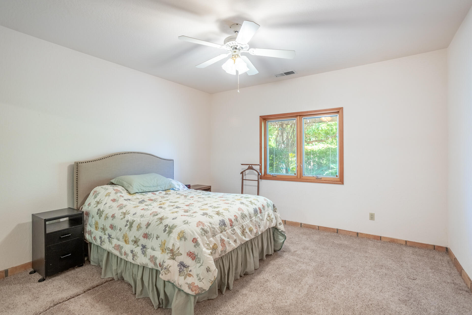 15560 China Rapids Drive Red Bluff, CA 96080 - Photo 27 of 43 a bedroom with a bed and a chandelier