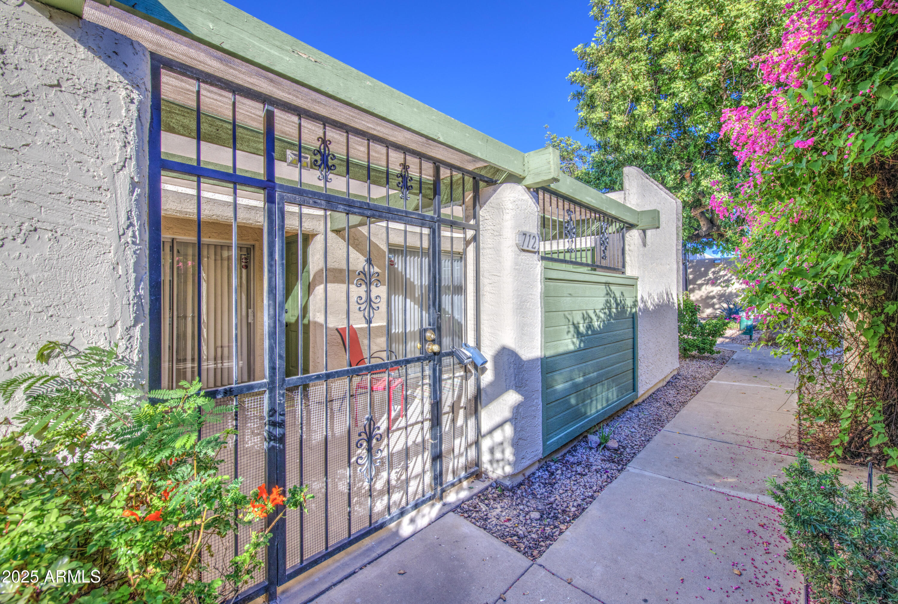 712 South Lebanon Lane Tempe, AZ 85288 - Photo 13 of 35 a view of a house with a small yard and plants