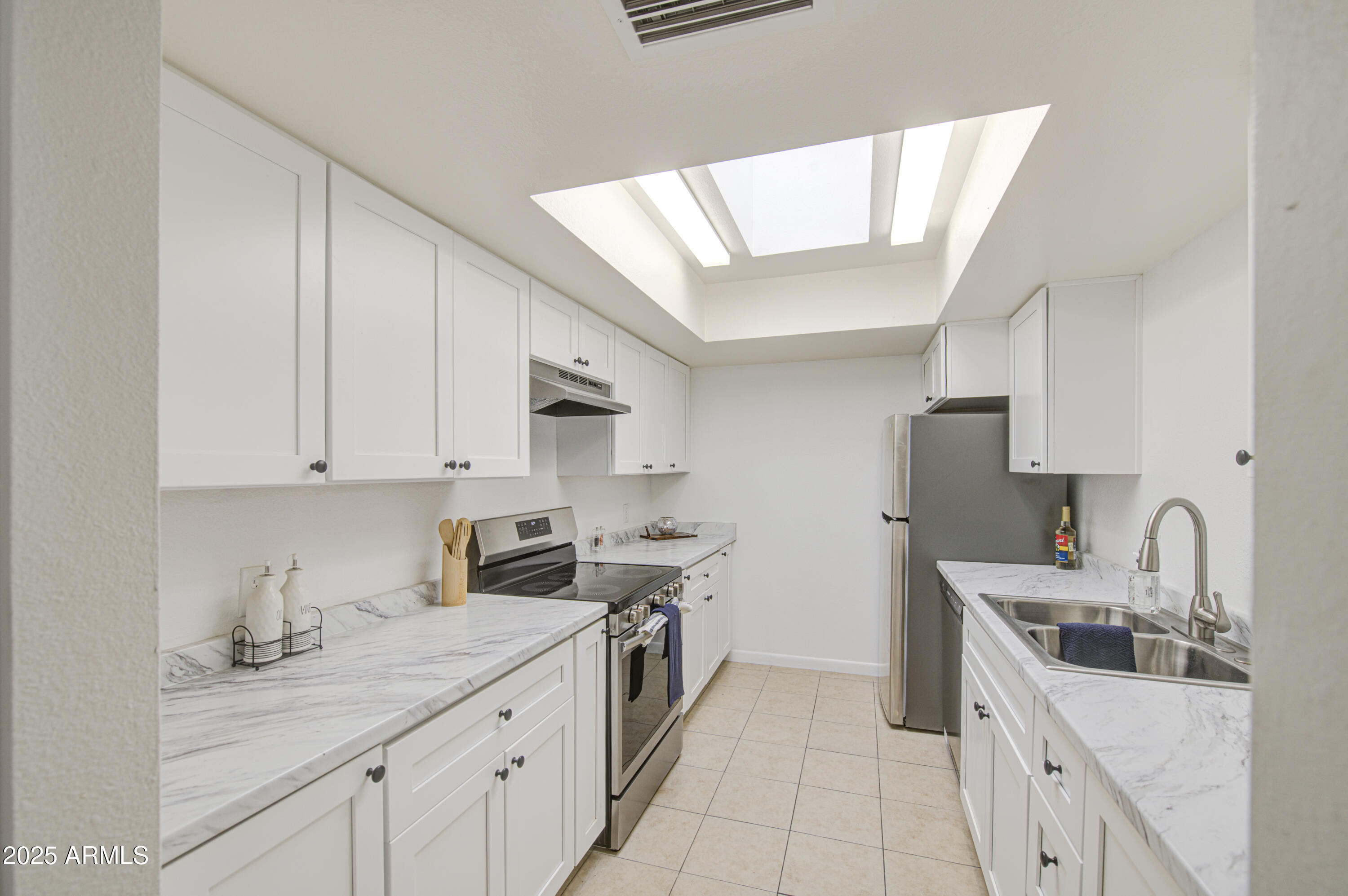 712 South Lebanon Lane Tempe, AZ 85288 - Photo 26 of 35 a kitchen with stainless steel appliances granite countertop a sink stove and cabinets