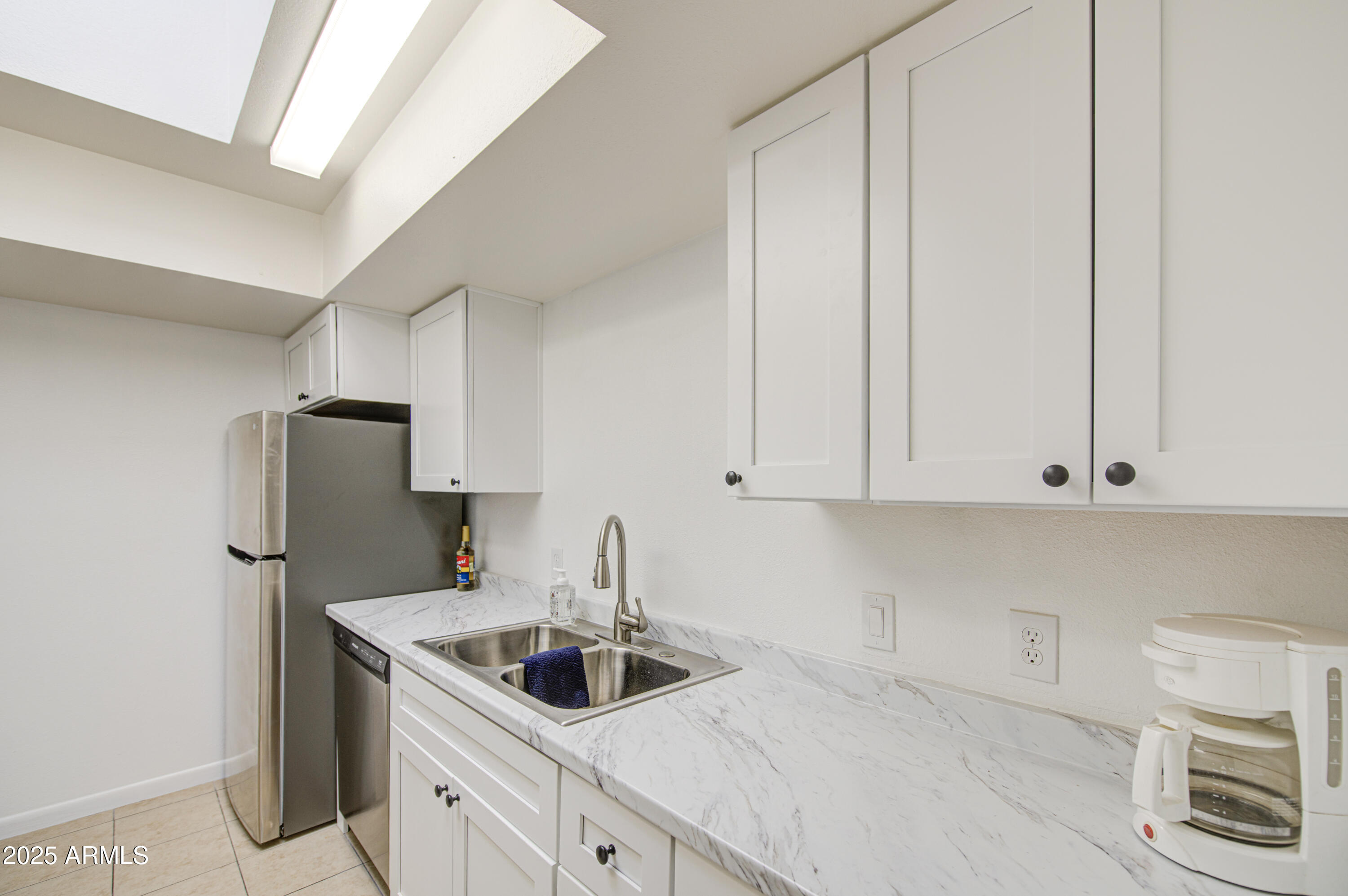 712 South Lebanon Lane Tempe, AZ 85288 - Photo 27 of 35 a kitchen with stainless steel appliances granite countertop a sink and a white cabinets