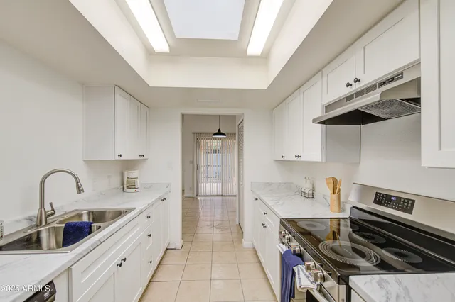 a kitchen with a sink stainless steel appliances and cabinets
